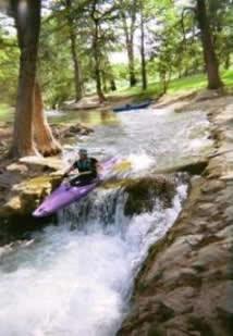 Kayak over waterfall on Medina River